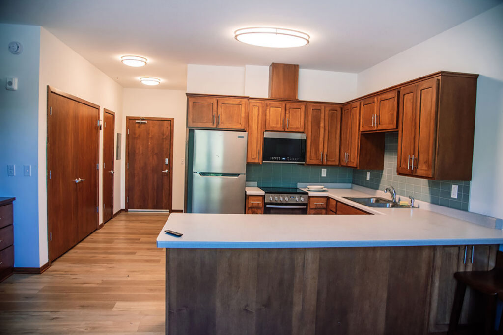 A modern kitchen with brown wooden cabinets and stainless steel appliances